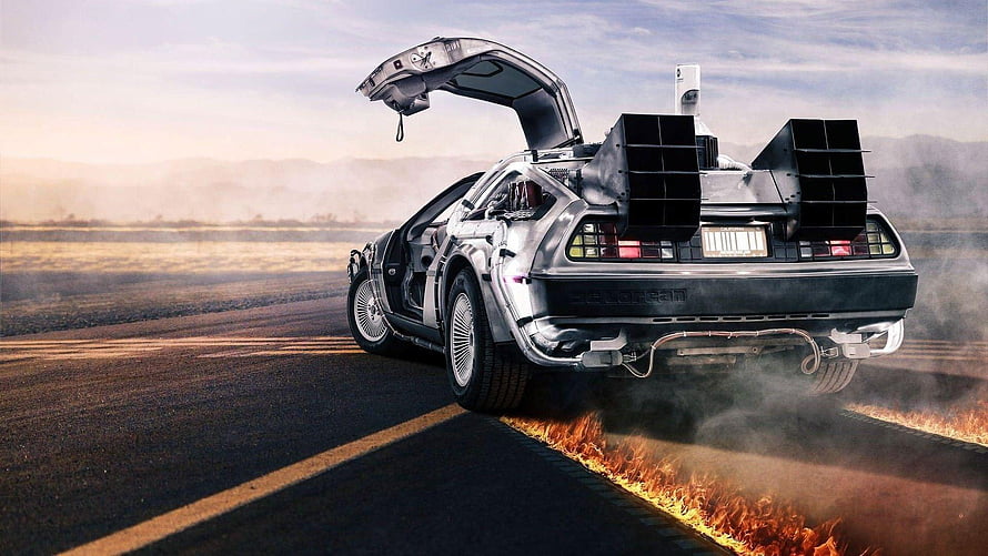 DeLorean Time Machine Burning Rubber on Desert Road at Sunset HD wallpaper