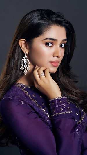 Krithi Shetty in a purple embroidered outfit with ornate jhumka earrings and a diamond ring HD phone wallpaper