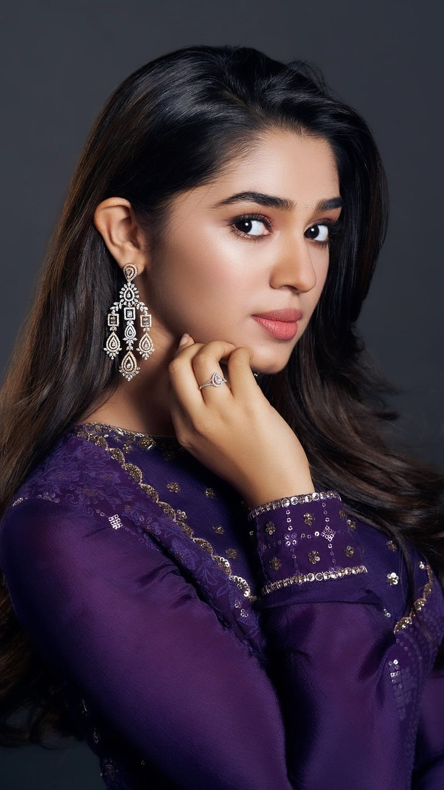 Krithi Shetty in a purple embroidered outfit with ornate jhumka earrings and a diamond ring HD phone wallpaper