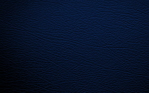 Deep Navy Blue Leather Texture Surface with Natural Grain and Subtle Lighting HD wallpaper