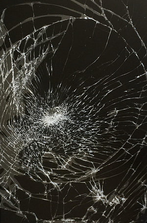 Shattered Glass Texture with Radiating Fracture Lines on Dark Background HD phone wallpaper
