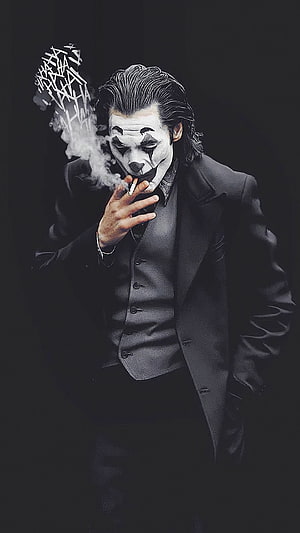 Joker in a dark suit smoking a cigarette with dramatic smoke against a black background HD phone wallpaper
