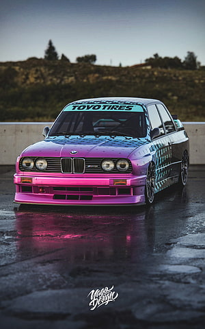Custom BMW M3 E30 with Vibrant Pink and Cyan Star Wrap on Wet Asphalt HD phone wallpaper