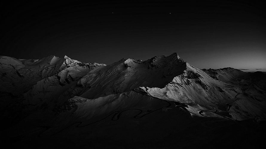 Monochrome Mountain Range Under a Starry Night Sky with Snow-Capped Peaks HD wallpaper
