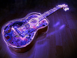 Glowing Neon Guitar Artwork with Sticker Collage on Wooden Floor HD wallpaper