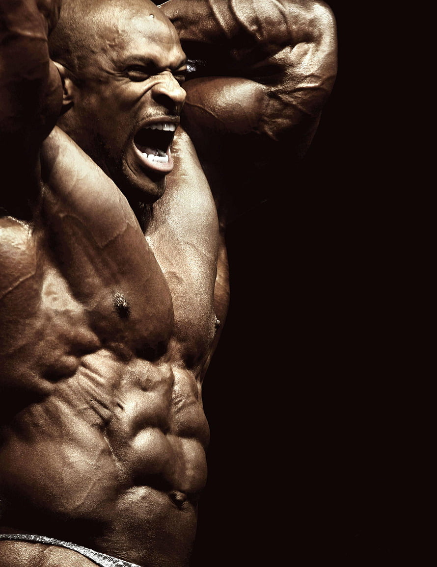 Ronnie Coleman Intense Bodybuilding Pose with Defined Muscles and Dramatic Lighting HD phone wallpaper