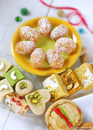 Assorted Indian Mithai Sweets with Coconut, Nuts, and Silver Leaf Garnish HD phone wallpaper