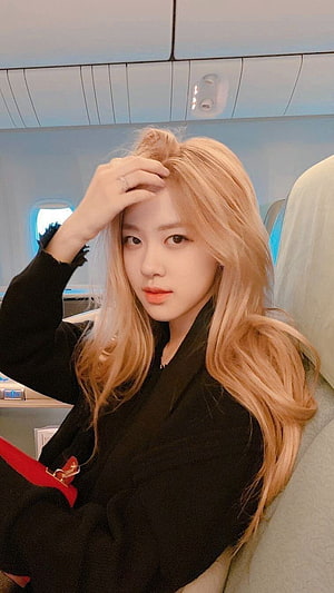 Rose from BLACKPINK with blonde hair on an airplane HD phone wallpaper