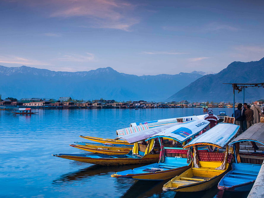 Colorful Shikara Boats Moored on Dal Lake in Kashmir with Snow-Capped Mountains HD wallpaper