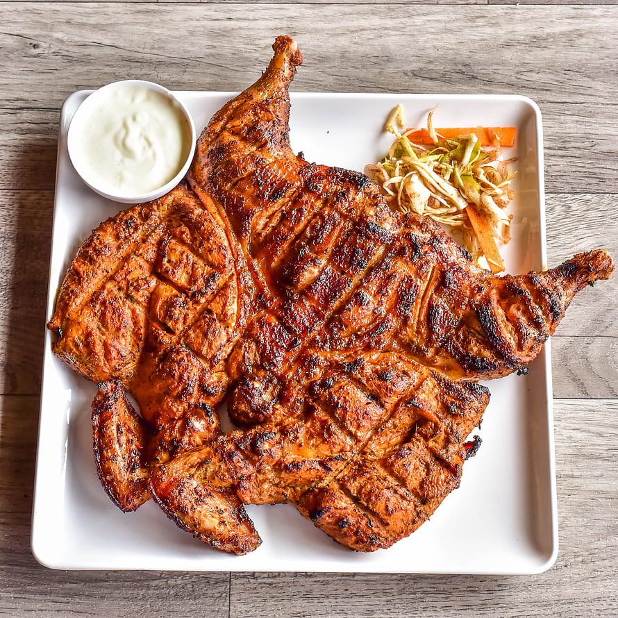 Grilled Whole Chicken with Crispy Skin Served on a White Platter with Side Salad and Dip HD phone wallpaper