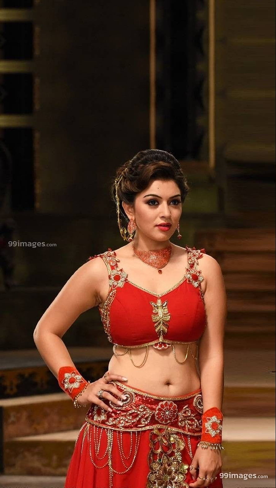 Hansika Motwani in a red embroidered lehenga with gold jewelry and traditional Indian bridal styling HD phone wallpaper