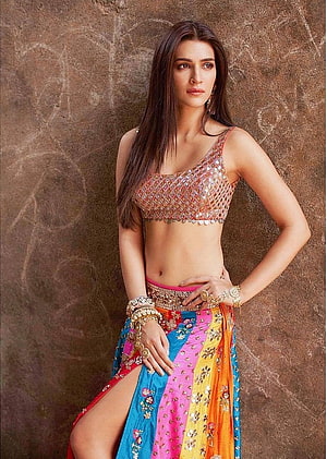 Kriti Sanon in a vibrant multicolored lehenga with a sequined crop top and traditional jewelry HD phone wallpaper