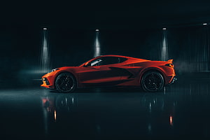 Chevrolet Corvette C8 Z06 in Vibrant Orange Under Dramatic Studio Lighting HD wallpaper