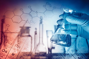 Gloved Hand Holding Erlenmeyer Flask in Chemistry Lab with Periodic Table Background HD wallpaper