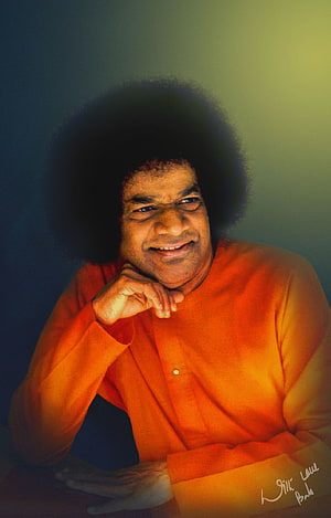 Sri Sathya Sai Baba Portrait in Orange Kurta with Warm Studio Lighting HD phone wallpaper
