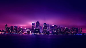 Vibrant Purple Skyline at Night with Glowing City Lights and Water Reflections HD wallpaper