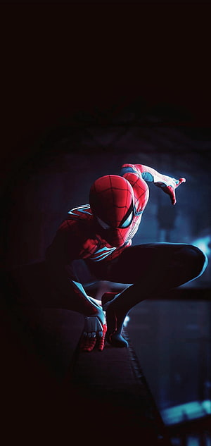 Spider-Man in a Crouched Action Pose on a Rooftop at Night HD phone wallpaper