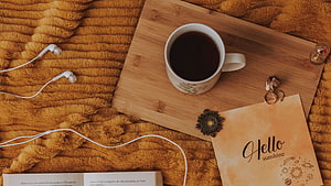 Cozy Flat Lay with Coffee, Earbuds, and Vintage Note on Fuzzy Blanket HD wallpaper