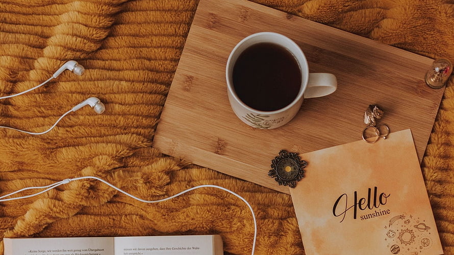 Cozy Flat Lay with Coffee, Earbuds, and Vintage Note on Fuzzy Blanket HD wallpaper