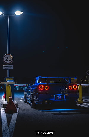 Nissan Skyline GT-R R34 Rear View at Night with LED Taillights and Blue Underglow HD phone wallpaper
