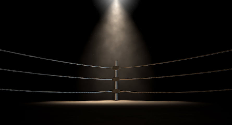 Empty Boxing Ring Under Dramatic Spotlight in Dark Arena HD wallpaper