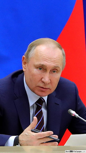 Vladimir Putin Speaking at a Formal Meeting with Russian Flag Background HD phone wallpaper