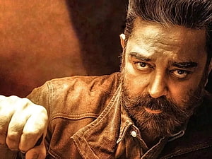 Kamal Haasan as Vikram in intense cinematic close-up with warm amber lighting HD wallpaper