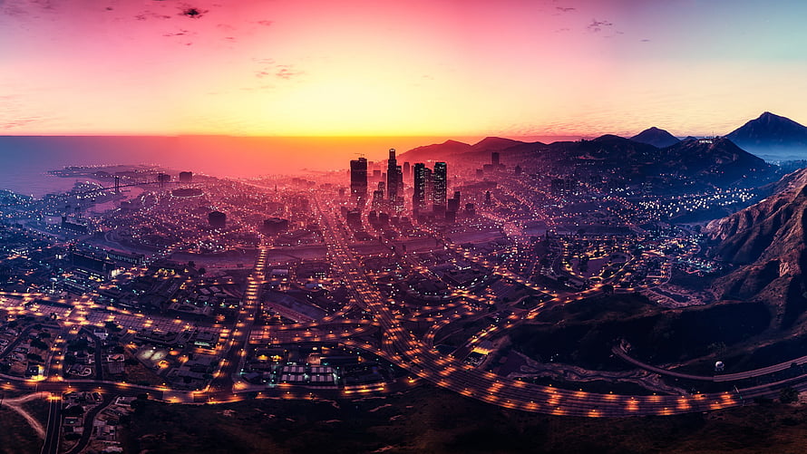 Grand Theft Auto V Los Santos Cityscape at Sunset with Vibrant Skyline and Mountain Silhouettes HD wallpaper