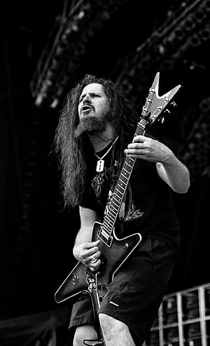 Dimebag Darrell performing live with electric guitar on stage in black and white HD phone wallpaper