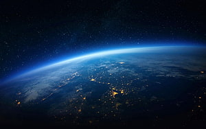 Earth at Night From Space: City Lights and Atmospheric Glow Against the Starry Cosmos HD wallpaper
