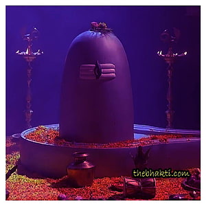 Sacred Shiva Lingam with Ritual Offerings and Oil Lamps in a Temple Setting HD phone wallpaper
