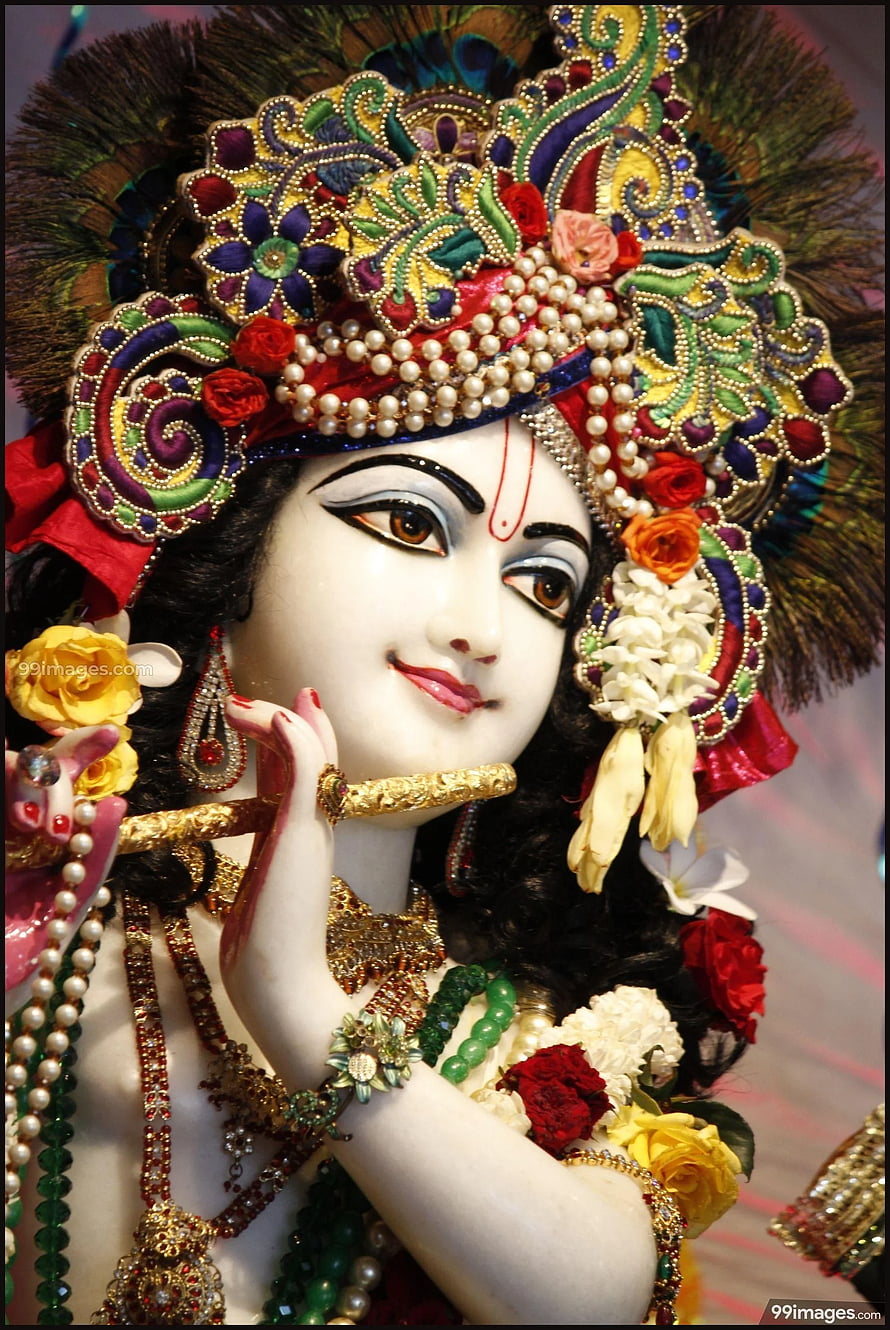 Ornate Radha Krishna Idol Adorned With Flowers, Pearls, and Traditional Jewelry HD phone wallpaper