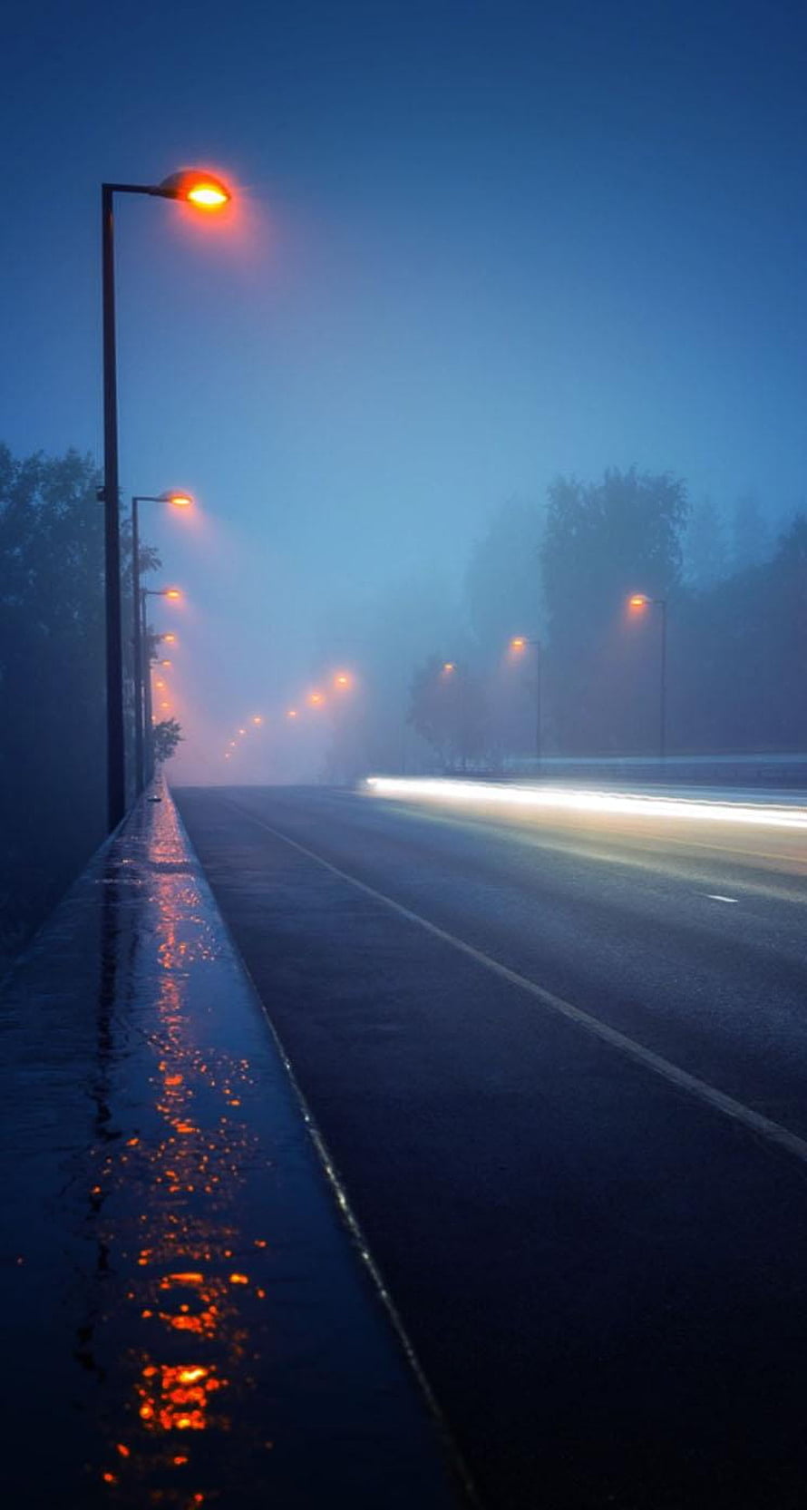 Foggy Night Highway With Glowing Street Lights And Wet Road Reflections HD phone wallpaper