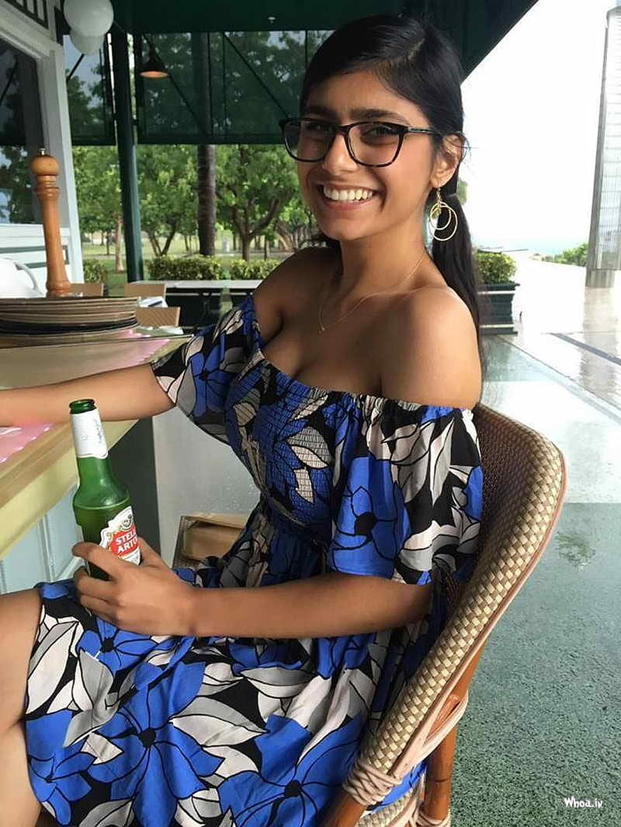Smiling Woman in Blue Floral Off-Shoulder Dress Holding Beer at Outdoor Cafe HD phone wallpaper