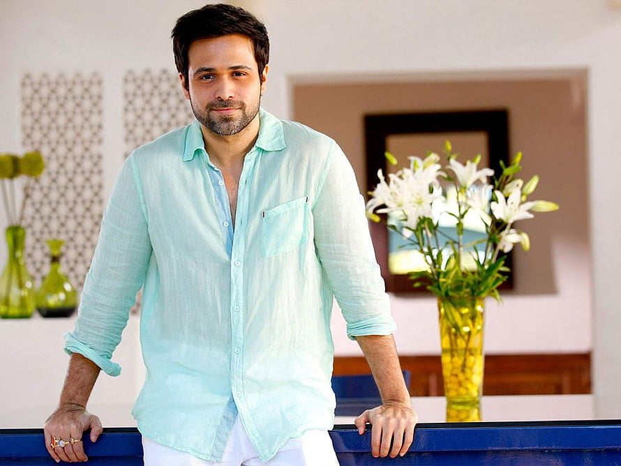 Emraan Hashmi in a light blue linen shirt with white lilies in a bright indoor setting HD wallpaper