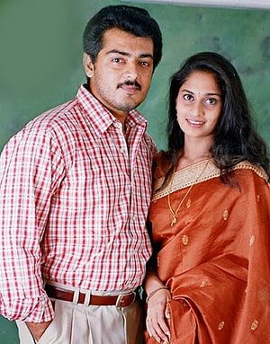 Ajith and Shalini in a warm portrait wearing a red check shirt and an orange sari HD phone wallpaper