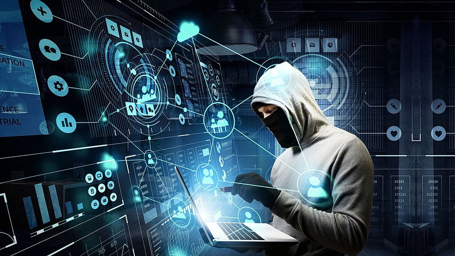 Masked Hacker in Hoodie Using Laptop with Glowing Cybersecurity Data Interface HD wallpaper