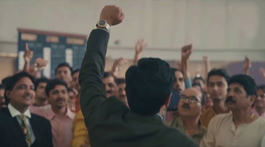 Scam 1992 Harshad Mehta Rally Scene with Raised Fist and Crowd HD wallpaper