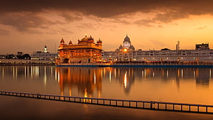 Golden Temple at Sunset with Reflections in the Sacred Pool, Amritsar HD wallpaper