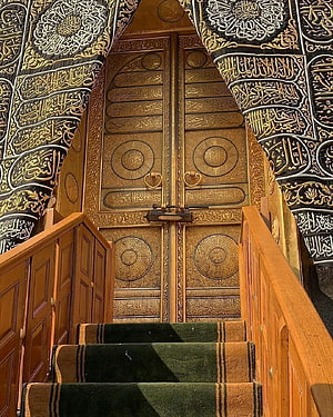Ornate Golden Kaaba Doorway with Arabic Calligraphy and Carpeted Staircase HD phone wallpaper