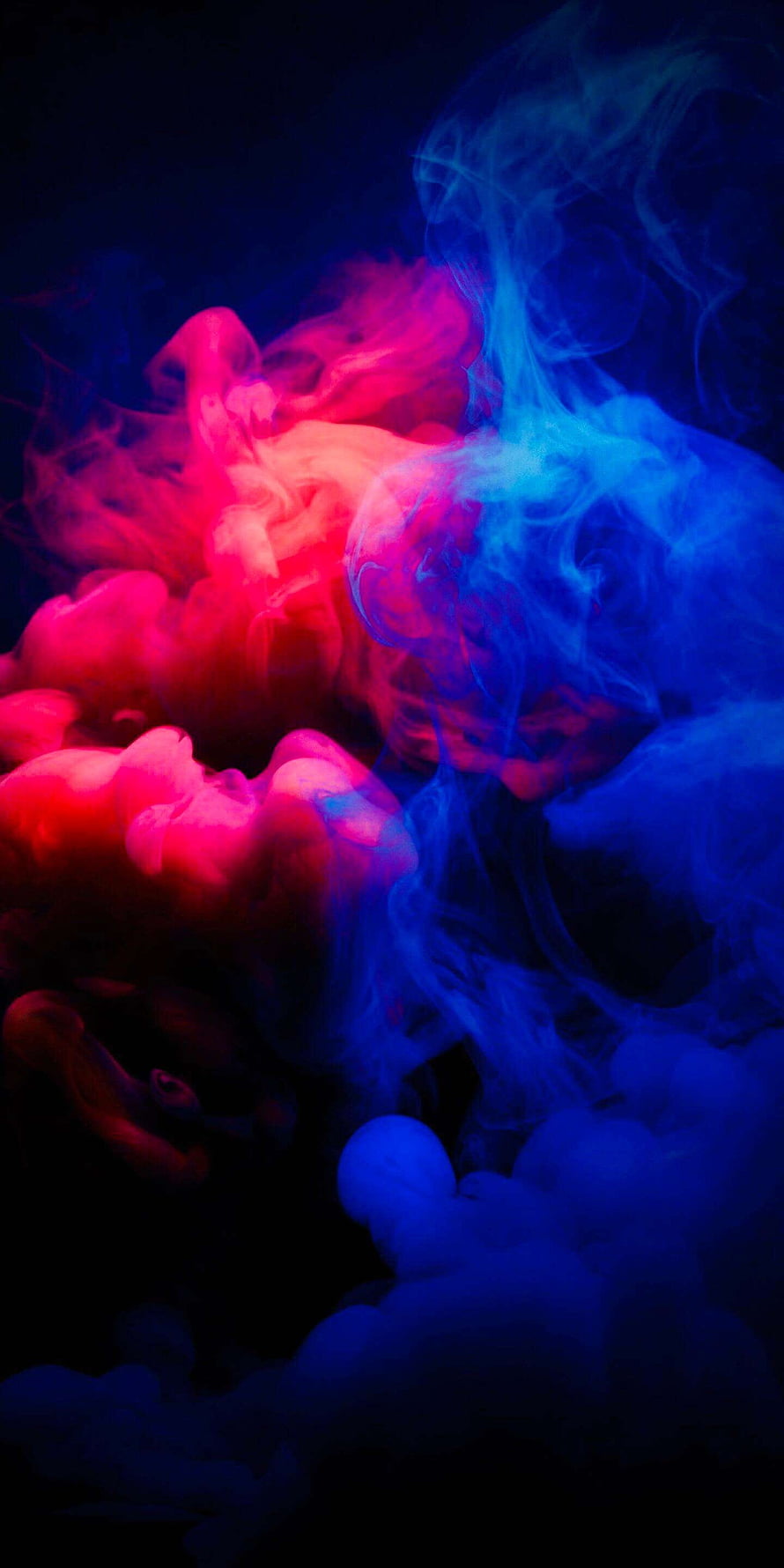 Vibrant Red and Blue Smoke Swirling Against a Dark Background HD phone wallpaper