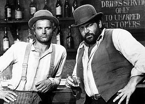 Bud Spencer and Terence Hill in a classic black and white western saloon scene HD wallpaper
