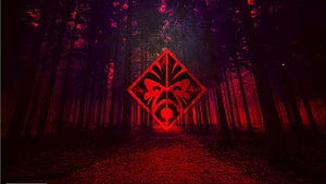 Glowing Red Tribal Mask Emblem in Dark Misty Forest at Night HD wallpaper