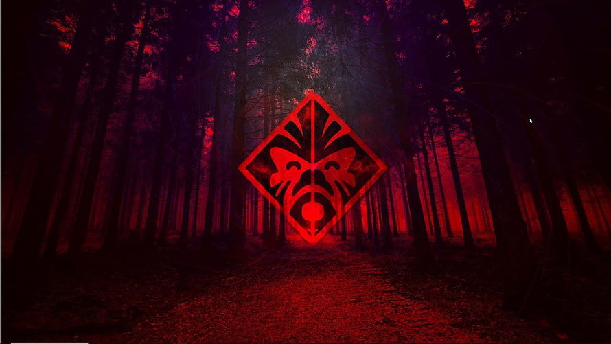 Glowing Red Tribal Mask Emblem in Dark Misty Forest at Night HD wallpaper
