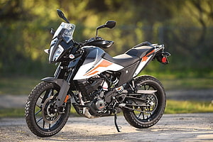 KTM 390 Adventure Motorcycle in White and Orange Parked on Gravel Road HD wallpaper
