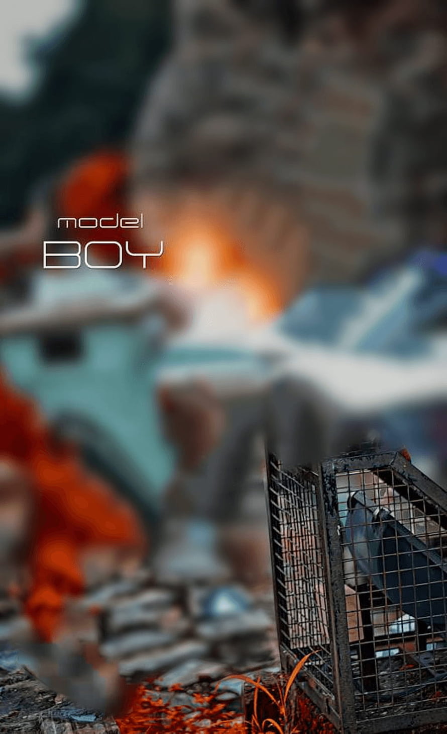 Model Boy: Dark Urban Scene with Caged Bird and Fire Glow HD phone wallpaper
