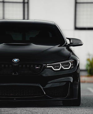 Black BMW M4 Front Fascia Close-Up with LED Headlights and M Badge HD phone wallpaper