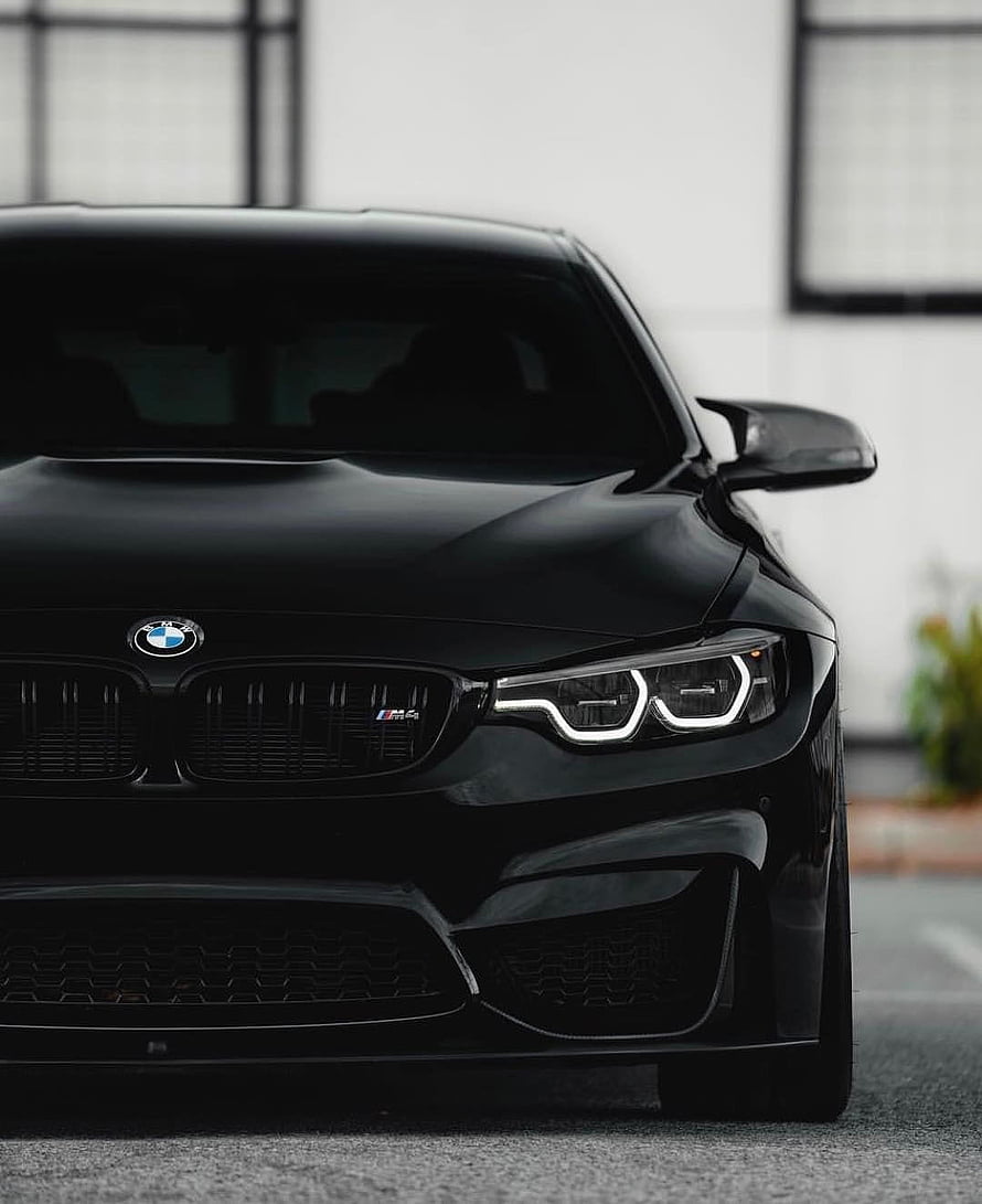 Black BMW M4 Front Fascia Close-Up with LED Headlights and M Badge HD phone wallpaper