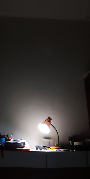 Moody Night Study Scene With Glowing Desk Lamp And Cluttered Workspace HD phone wallpaper