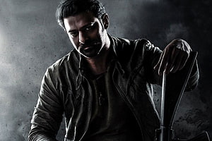 Prabhas in Salaar promotional portrait with dark leather jacket and intense expression HD wallpaper